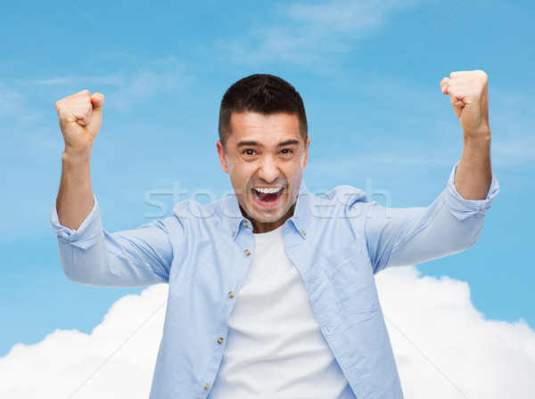 Feliz risonho homem as mãos levantadas felicidade gesto Foto stock © dolgachov