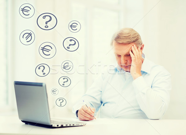 old man filling a form at home Stock photo © dolgachov
