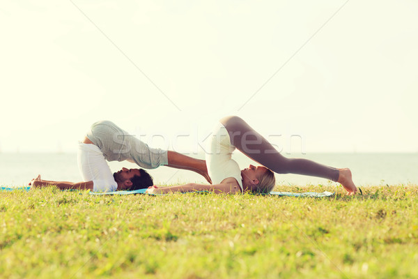 Mosolyog pár készít jóga kint fitnessz Stock fotó © dolgachov