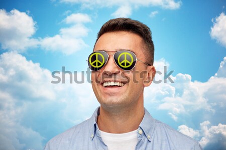 face of laughing man in green peace sunglasses Stock photo © dolgachov