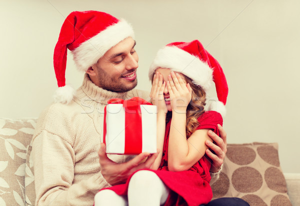 smiling daughter waiting for a present from father Stock photo © dolgachov