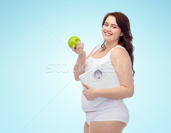 happy young plus size woman holding scales Stock photo © dolgachov