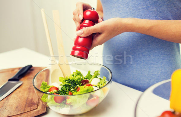 close up of woman cooking vegetable salad at home Stock photo © dolgachov