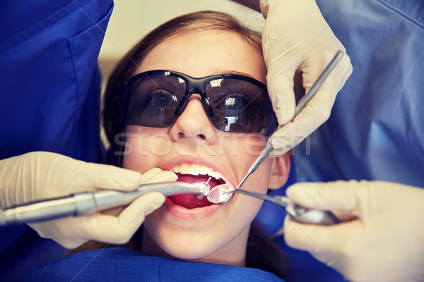 female dentists treating patient girl teeth Stock photo © dolgachov