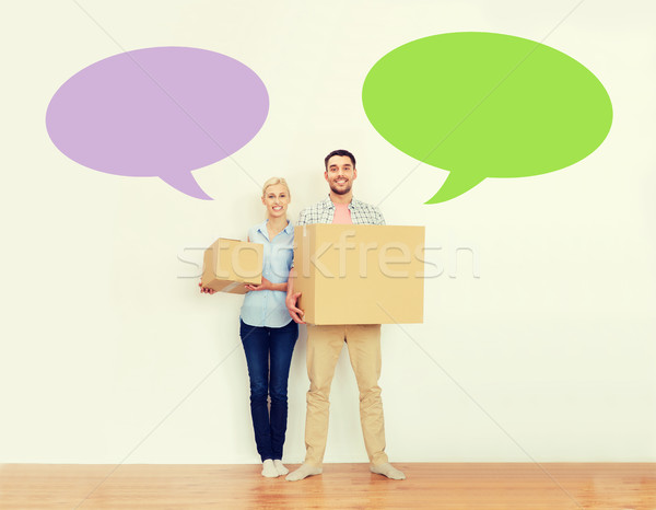 couple with cardboard boxes moving to new home Stock photo © dolgachov