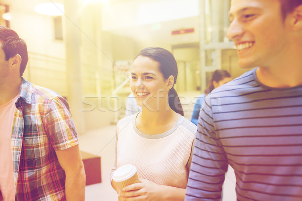 group of smiling students with paper coffee cups Stock photo © dolgachov