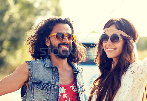 Stock photo: smiling young hippie couple over minivan car