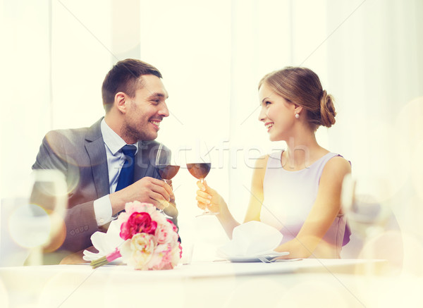 young couple with glasses of wine at restaurant Stock photo © dolgachov