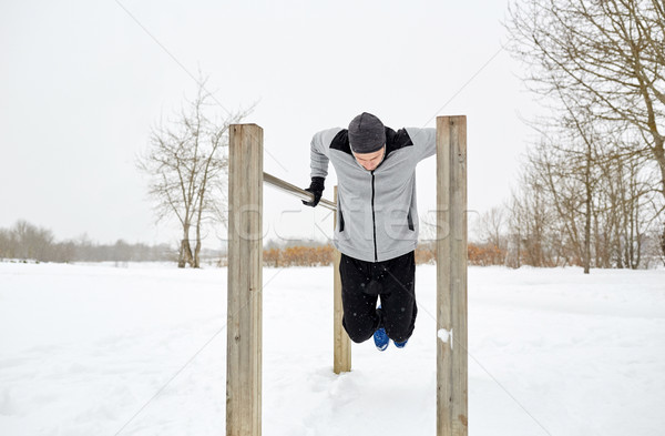 Junger Mann parallel Bars Winter Fitness Stock foto © dolgachov