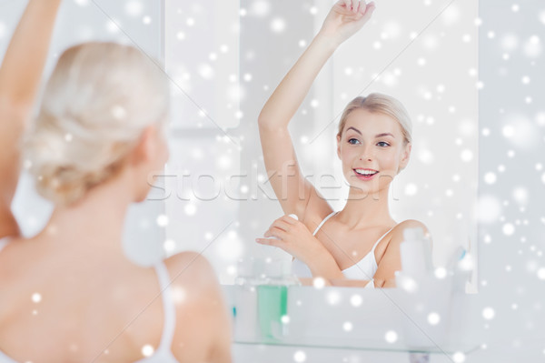 woman with antiperspirant deodorant at bathroom Stock photo © dolgachov