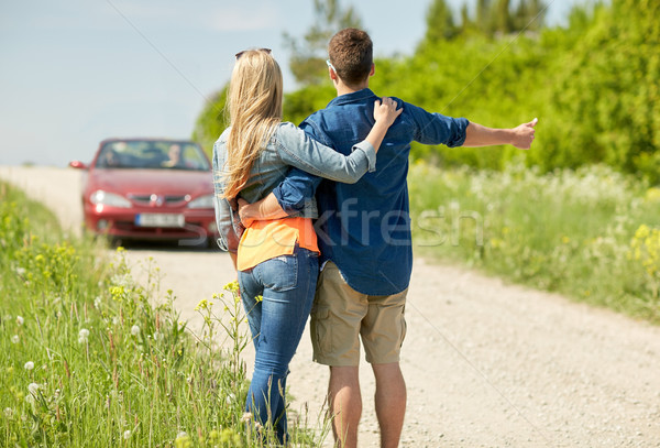couple hitchhiking and stopping car on countryside Stock photo © dolgachov