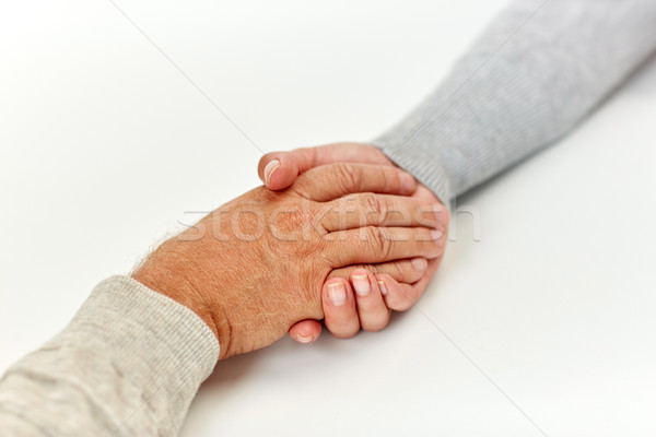Közelkép idős férfi fiatal nő kéz a kézben aggkor támogatás Stock fotó © dolgachov
