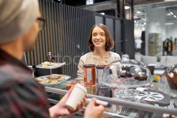 woman and man or barman with coffee cup at cafe Stock photo © dolgachov