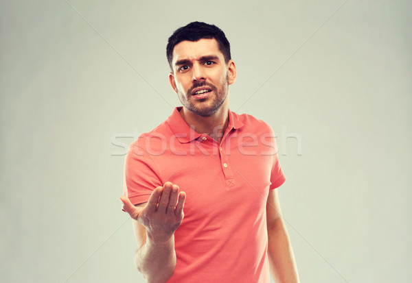 Stock photo: arguing man proving something over gray
