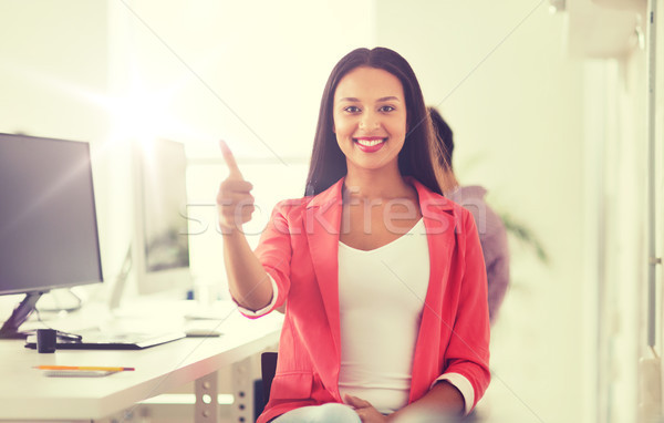 happy african woman showing thumbs up at office Stock photo © dolgachov