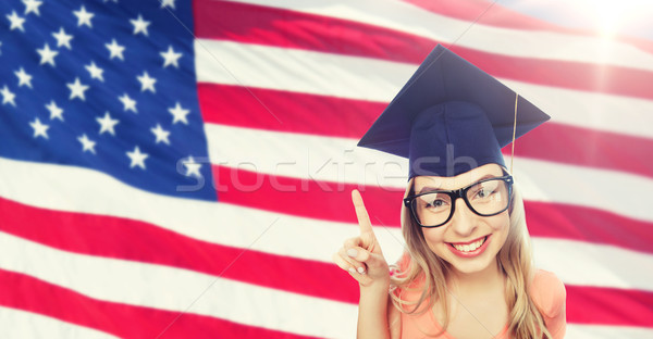 smiling young student woman in mortarboard Stock photo © dolgachov