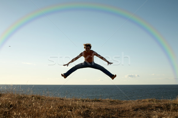 learning to fly under rainbow Stock photo © dolgachov