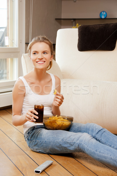 smiling teenage girl with remote control Stock photo © dolgachov