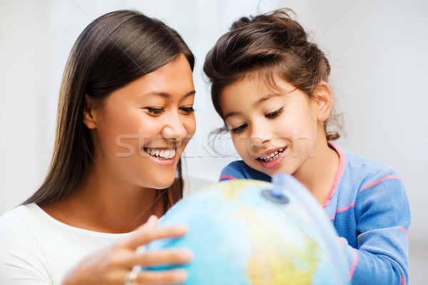 mother and daughter with globe Stock photo © dolgachov