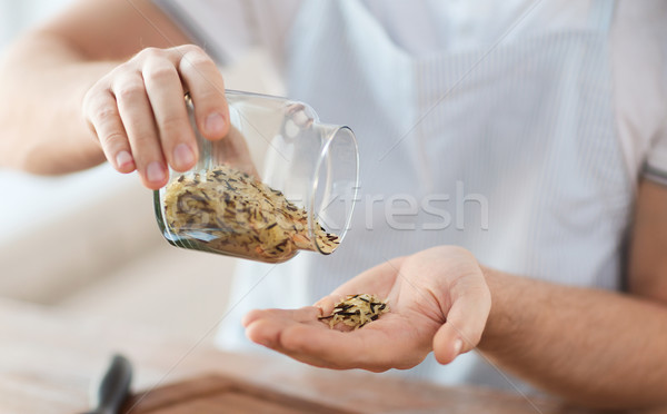 male emptying jar with white and wild black rice Stock photo © dolgachov