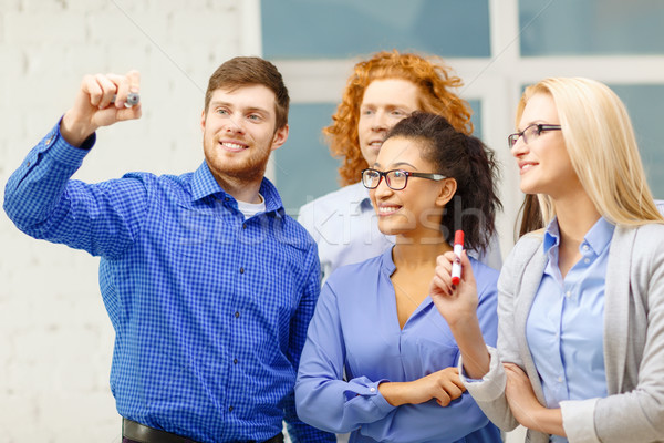 smiling creative team writing on virtual screen Stock photo © dolgachov