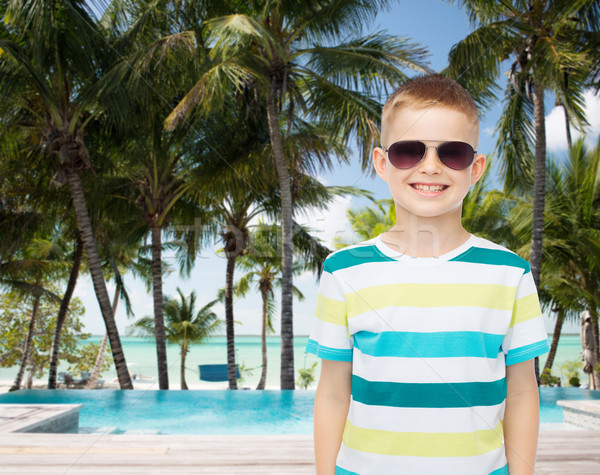 smiling little boy over green background Stock photo © dolgachov