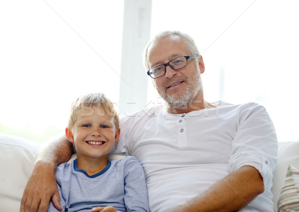 Stock photo: smiling grandfather and grandson at home