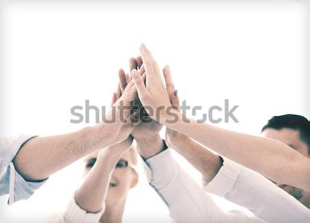 happy business team giving high five in office Stock photo © dolgachov