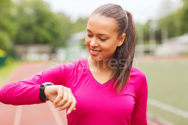 smiling woman running on track outdoors Stock photo © dolgachov