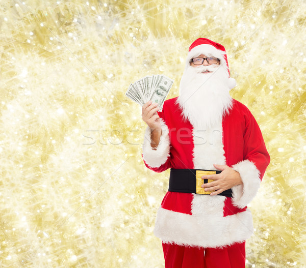 Stock photo: man in costume of santa claus with dollar money