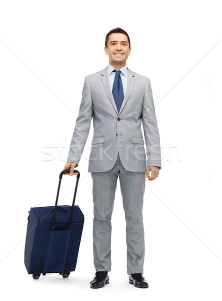 happy businessman in suit with travel bag Stock photo © dolgachov