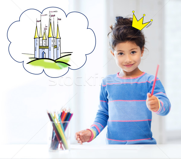 Stock photo: happy little girl showing pencil or crayon