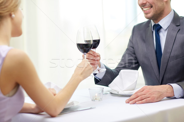 happy couple with glasses of wine at restaurant Stock photo © dolgachov