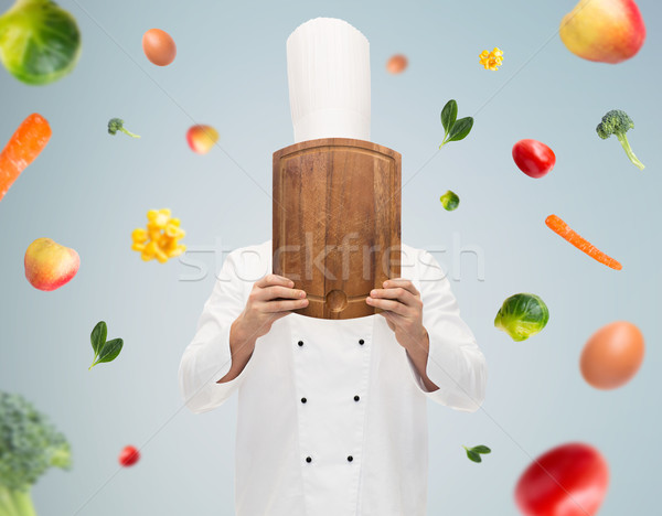 male chef cook covering face with cutting board Stock photo © dolgachov