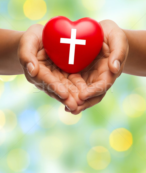 close up of hands holding heart with cross symbol Stock photo © dolgachov