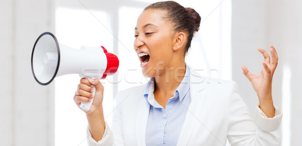 strict businesswoman shouting in megaphone Stock photo © dolgachov
