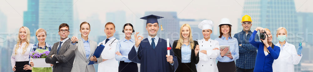 happy bachelor with diploma over professionals Stock photo © dolgachov