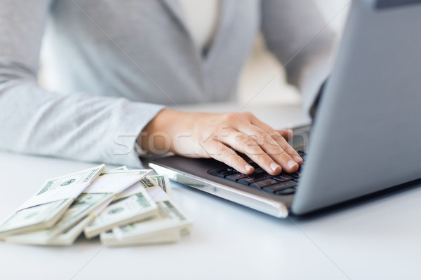 close up of woman hands with laptop and money Stock photo © dolgachov
