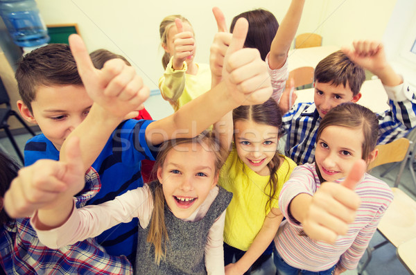 group of school kids showing thumbs up Stock photo © dolgachov
