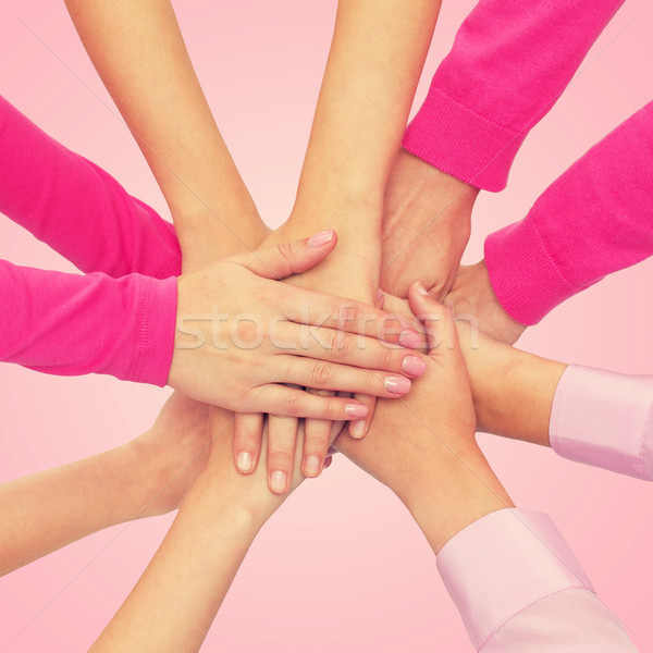 close up of women with hands on top Stock photo © dolgachov