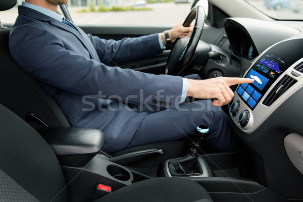 close up of man driving car with board computer Stock photo © dolgachov