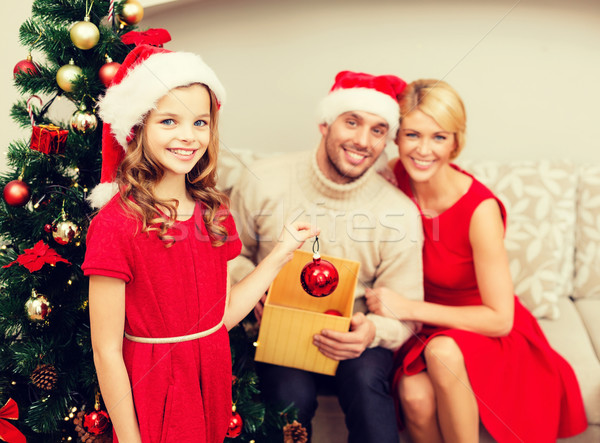 smiling family decorating christmas tree Stock photo © dolgachov