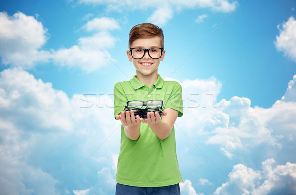 happy boy in green polo t-shirt holding eyeglasses Stock photo © dolgachov