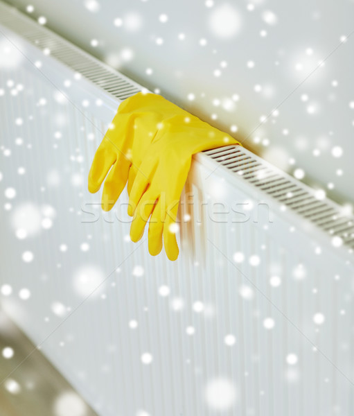 close up of rubber gloves hanging on heater Stock photo © dolgachov