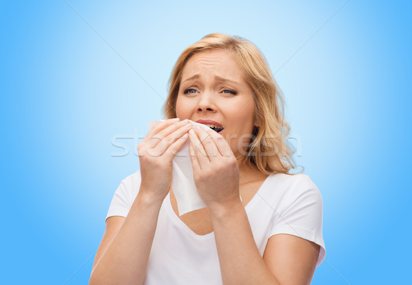 unhappy woman with paper napkin sneezing Stock photo © dolgachov