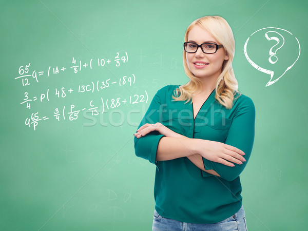 happy woman in eyeglasses over school blackboard Stock photo © dolgachov