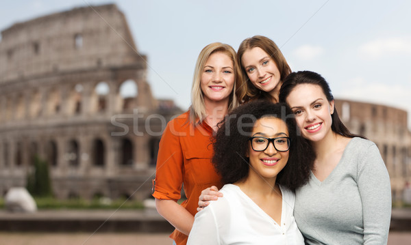 group of happy different women over coliseum Stock photo © dolgachov