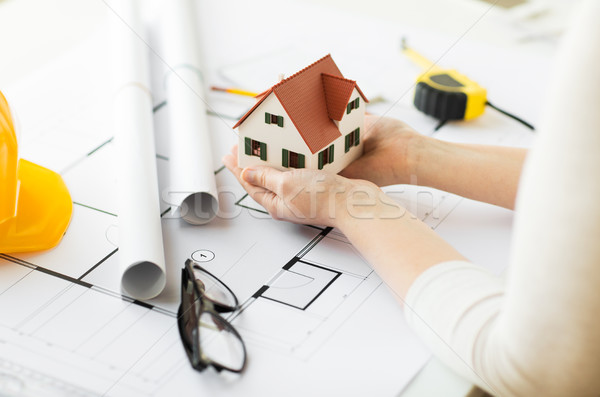 close up of hands with house model above blueprint Stock photo © dolgachov