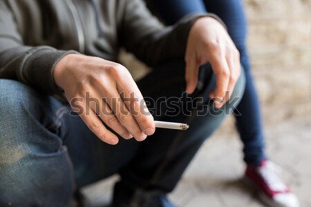 Stock photo: close up of young man smoking cigarette