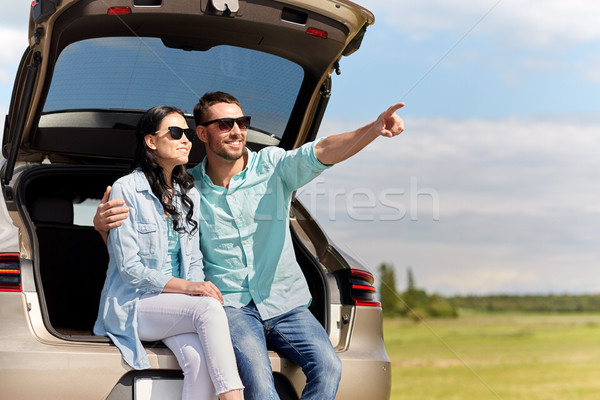 happy couple hugging at open hatchback car trunk Stock photo © dolgachov